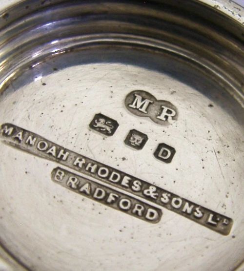 An Art Deco sterling silver twin-handled cup featuring horizontal incised line detailing, loop handles, a flared foot, and a gilt interior. View V