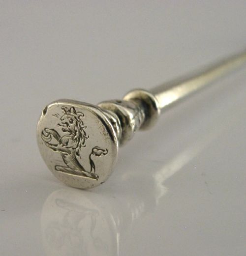 A Victorian sterling silver seal top fork featuring four tines and hallmarks along the slender stem. View III
