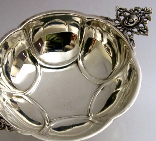 A Dutch solid silver lobed brandy bowl featuring twin ornate openwork cast handles with scrollwork details. View III