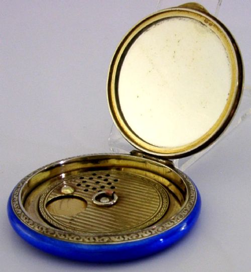 An open Art Deco sterling silver powder compact featuring a cobalt blue enamel rim and a hand-painted landscape scene on the lid interior. View VII