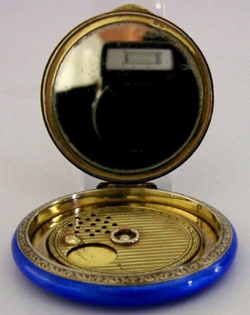An open Art Deco sterling silver powder compact featuring a cobalt blue enamel rim and a hand-painted landscape scene on the lid interior. View VIII