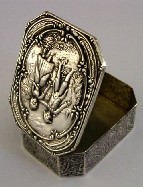 An octagonal antique silver table box featuring a detailed repousse scene of a couple in 18th-century attire within a scrollwork frame. View III