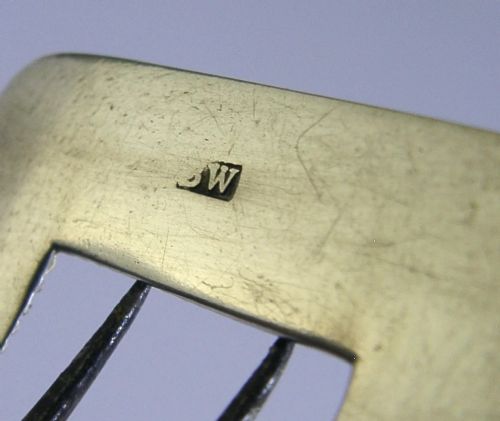 A pair of curved Georgian sterling silver shoe buckles featuring beaded borders and steel mechanism prongs. View IX