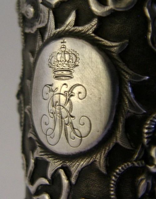 A cylindrical Chinese export silver beaker featuring high-relief repousse dragon motifs and an oval cartouche engraved with a royal monogram beneath a crown. View VI