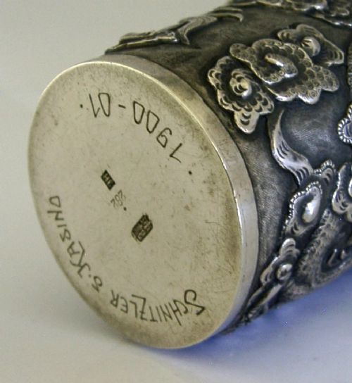 A cylindrical Chinese export silver beaker featuring high-relief repousse dragon motifs and an oval cartouche engraved with a royal monogram beneath a crown. View VII