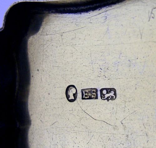 An engraved Victorian sterling silver snuff box with shaped edges, scrollwork border, and engraved inscription on the lid. View IX