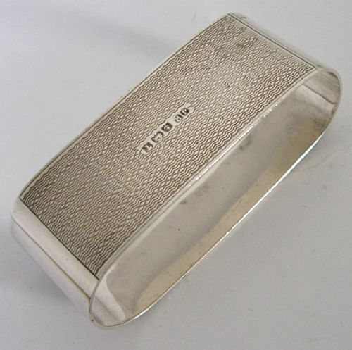 An Art Deco sterling silver napkin ring featuring engine-turned geometric engraving, displayed inside an open blue silk and velvet-lined fitted case. View VII