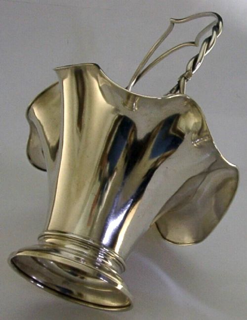 An antique solid silver Art Nouveau basket bowl with a fluted, lobed rim and an overhead twisted wire swing handle. View II