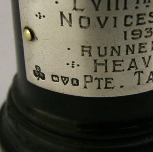 A silver-plated figurine of a boxer in a fighting stance mounted on a dark cylindrical wooden base with an engraved inscription plate. View VII