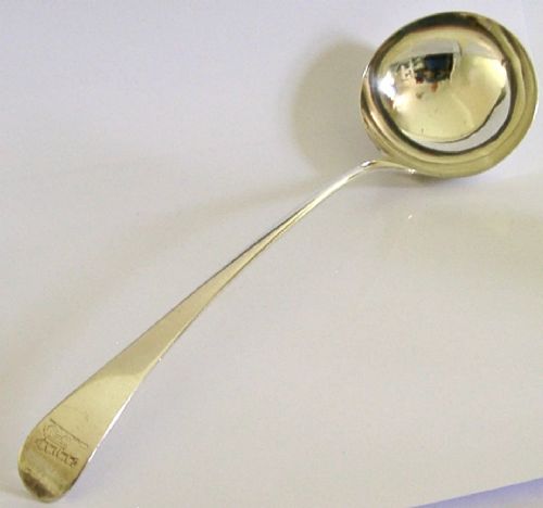 A Georgian sterling silver soup ladle featuring a rounded bowl, long handle, and engraved heraldic crest. View IV