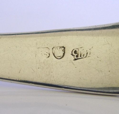 A Georgian sterling silver soup ladle featuring a rounded bowl, long handle, and engraved heraldic crest. View VII
