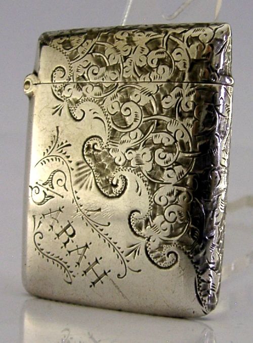 An engraved sterling silver Victorian vesta case featuring elaborate scrollwork detailing and the engraved name Sarah. View II