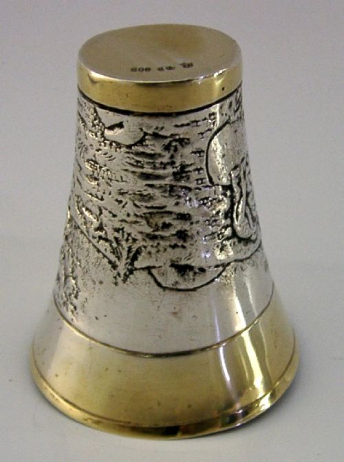 An antique 800 solid silver beaker with gilded rims featuring an embossed relief scene of a golfer. View V