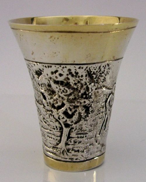 An antique 800 solid silver beaker with gilded rims featuring an embossed relief scene of a golfer. View VI
