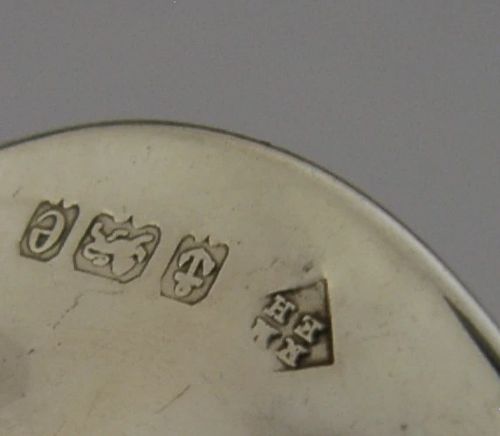 An Edwardian sterling silver menu holder featuring a circular relief of a maidens head set within an oval ring atop a domed base bearing British hallmarks. View VIII