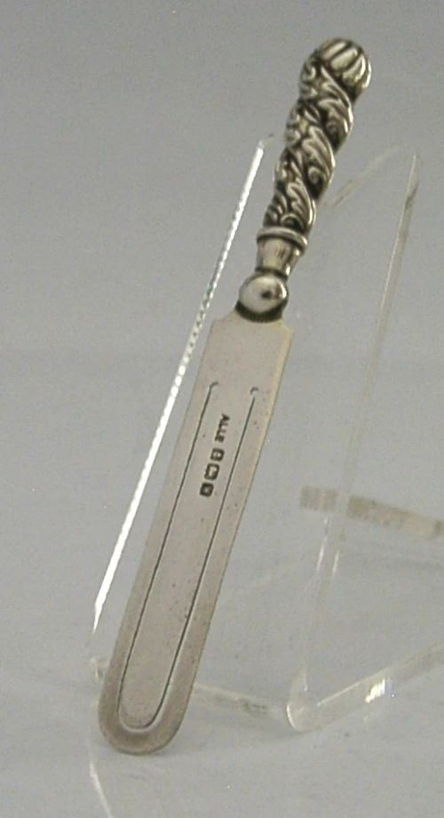 An antique sterling silver page marker featuring a flat clipped body with clear hallmarks and a decorative spiralled handle. View III
