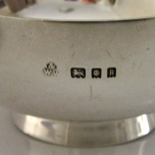 A polished sterling silver shallow drinking cup featuring two flat side handles and British hallmarks stamped on the exterior wall. View VIII