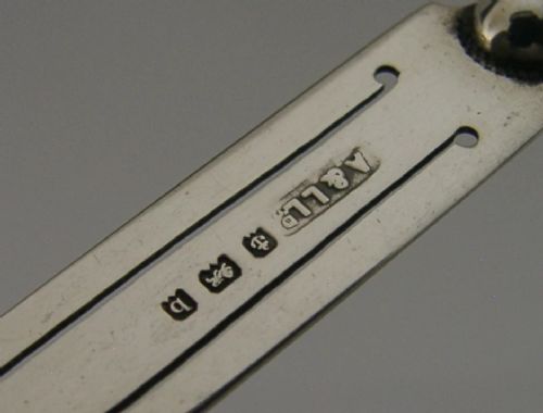 An antique sterling silver bookmark with a spiral twist handle and a flat page clip bearing English hallmarks. View VI