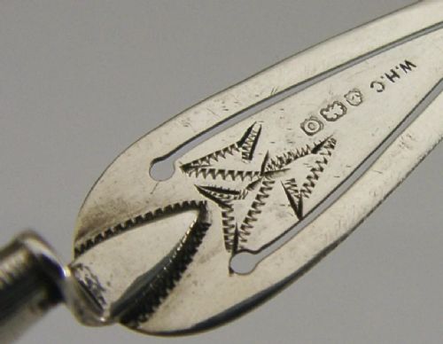 An Edwardian sterling silver bookmark with a tapered mother of pearl handle and an engraved silver clip bearing the Isle of Man triskelion emblem. View II