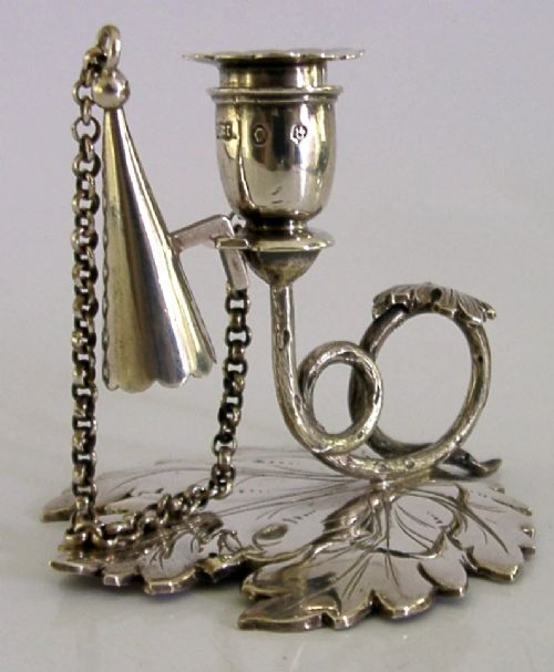 An early Victorian sterling silver chamberstick featuring a shaped leaf base, a coiled vine handle, and an attached chain with a conical snuffer. View III