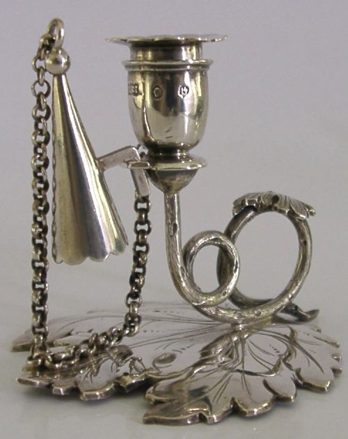 An early Victorian sterling silver chamberstick featuring a shaped leaf base, a coiled vine handle, and an attached chain with a conical snuffer. View VII