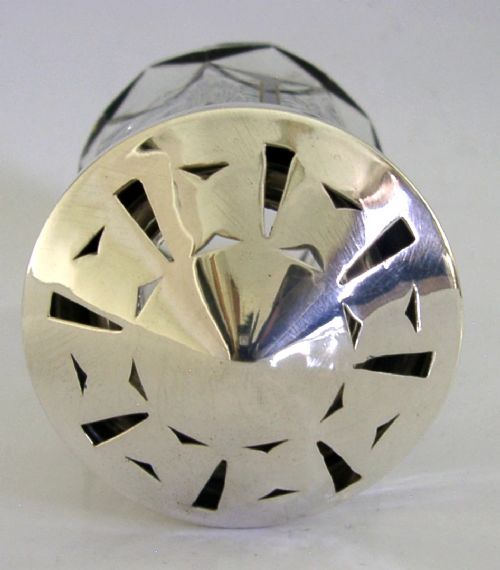 An Art Deco sugar caster featuring a faceted cut-glass body with black geometric enamel details and a pierced sterling silver top. View III