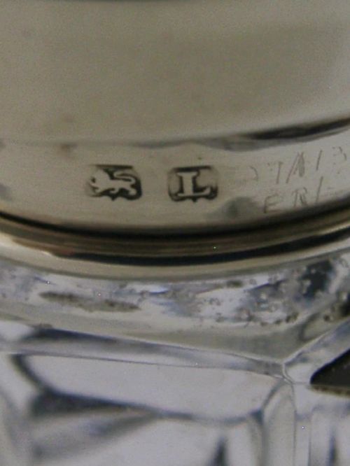 An Art Deco sugar caster featuring a faceted cut-glass body with black geometric enamel details and a pierced sterling silver top. View VIII