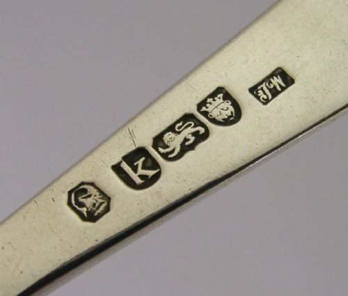 An 18th-century Georgian sterling silver basting spoon featuring a long, tapered stem and a polished oval bowl. View II