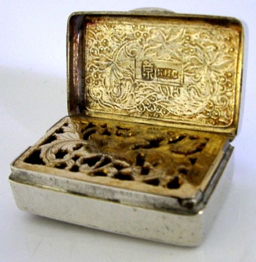 An open nineteenth-century rectangular Chinese export silver vinaigrette box showing a gilded interior with an intricately pierced floral grille. View VII