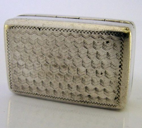 An open nineteenth-century rectangular Chinese export silver vinaigrette box showing a gilded interior with an intricately pierced floral grille. View IX