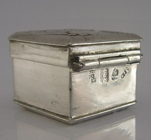 A small rectangular sterling silver box with a hinged lid featuring a raised relief scene of a figure walking a dog near a rustic building. View VIII