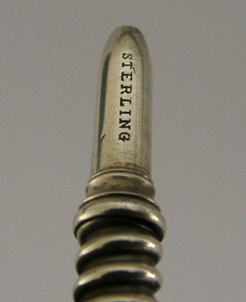 A Victorian sterling silver propelling pencil featuring a ribbed barrel design and a rounded fluted finial. View VII