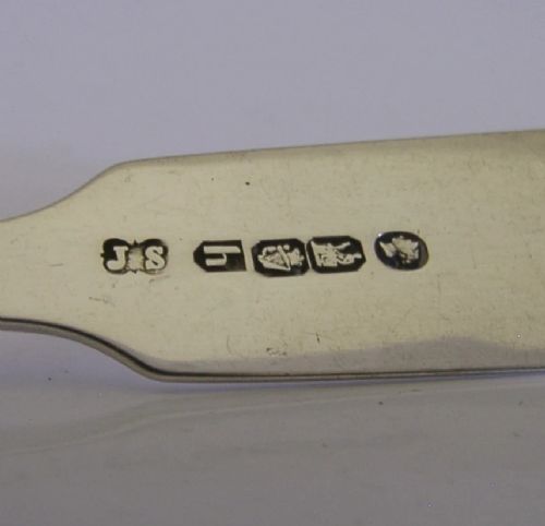 A pair of Victorian sterling silver sugar tongs featuring a classic Fiddle pattern handle and spoon-shaped grips. View VIII