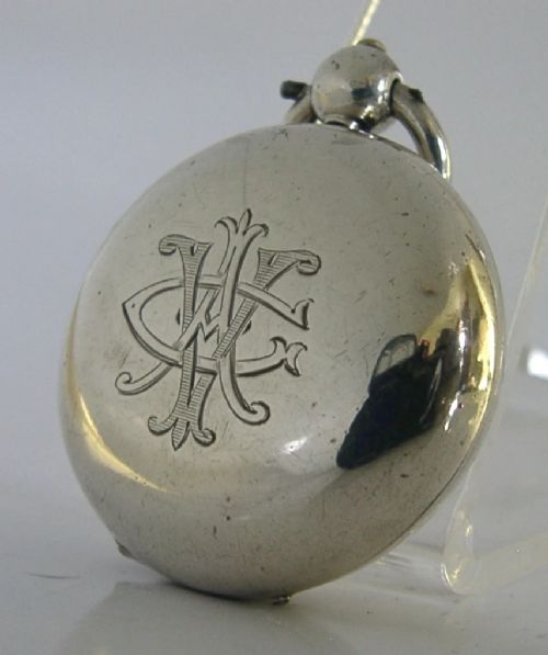An open circular Victorian sterling silver sovereign case displaying an internal spring-loaded coin platform and hallmarks on the inner lid. View III