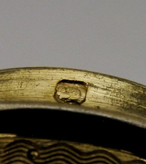 A circular French sterling silver gilt trinket box featuring engine-turned guilloche detailing and a decorative laurel leaf border. View VII