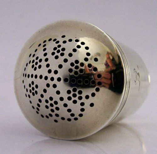 A Georgian sterling silver cylindrical caster top showing a hand-pierced dome with a gilded interior. View IV