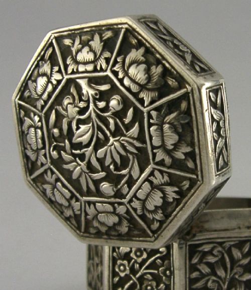 An octagonal Chinese export silver box featuring relief panels with floral and botanical motifs. View II