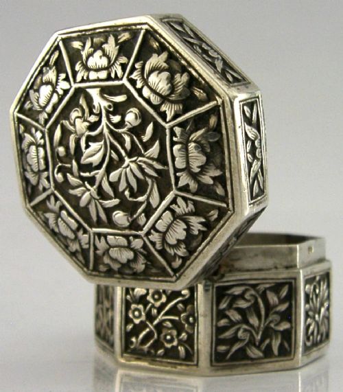 An octagonal Chinese export silver box featuring relief panels with floral and botanical motifs. View III