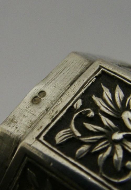 An octagonal Chinese export silver box featuring relief panels with floral and botanical motifs. View VI