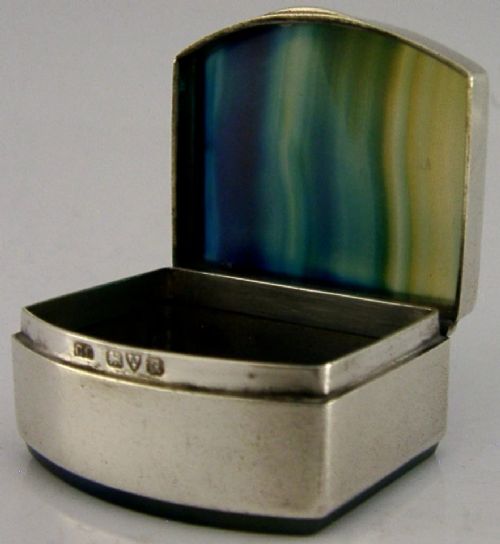 A small hinged sterling silver box featuring an arched lid mounted with a polished blue and yellow banded agate stone. View III