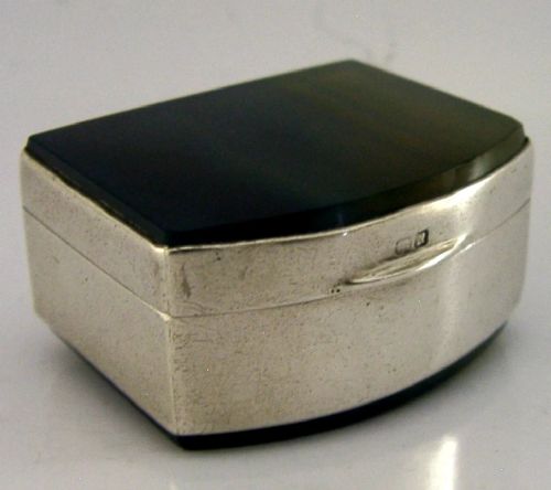 A small hinged sterling silver box featuring an arched lid mounted with a polished blue and yellow banded agate stone. View VII