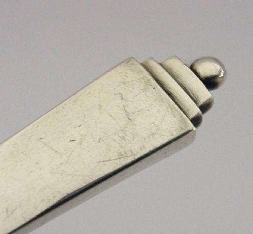 A sterling silver Stilton cheese scoop featuring a tapered handle ending in a stepped pyramid finial. View II