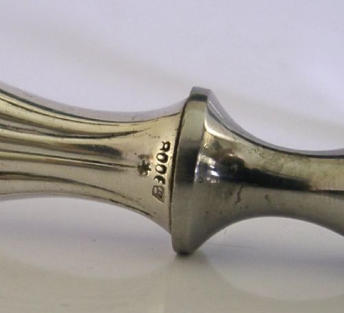 A pair of mid-century German nutcrackers featuring smooth silver handles and serrated metal jaws connected by a central hinge. View IX
