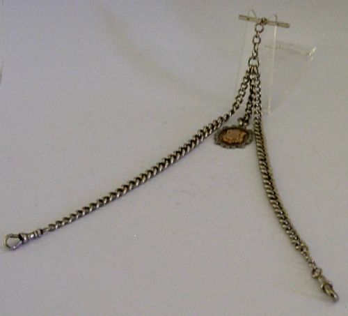 A solid sterling silver double Albert watch chain featuring curb links, a T-bar, two swivel clasps, and a decorative shield fob. View IV
