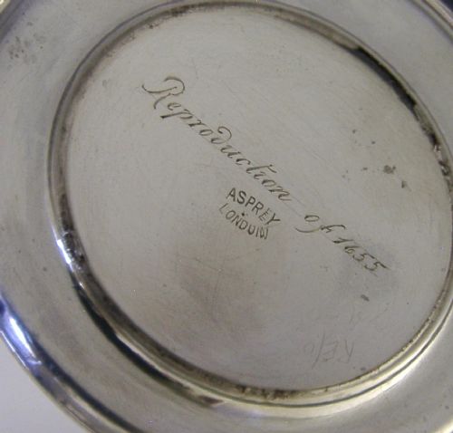 An Edwardian sterling silver twin-handled porringer cup with chased oval panels, an engraved monogram, and ornate scroll handles. View V