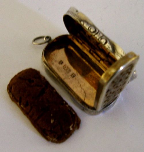 An antique Victorian sterling silver vinaigrette box featuring a shaped lobed outline, engine-turned geometric engraving, and a central engraved monogram cartouche. View XI