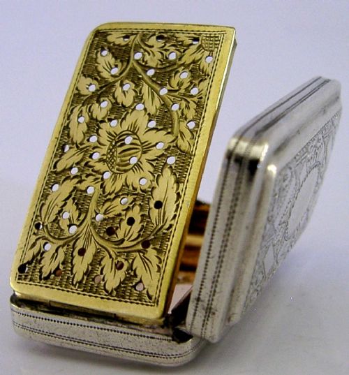 An open rectangular Georgian sterling silver vinaigrette box displaying an engraved exterior and a pierced gold-gilded inner grille featuring floral leaf patterns. View III