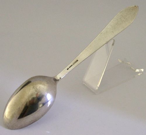 An antique Chinese export silver spoon featuring a detailed chased dragon design sculpted along its handle and a polished oval bowl. View VI