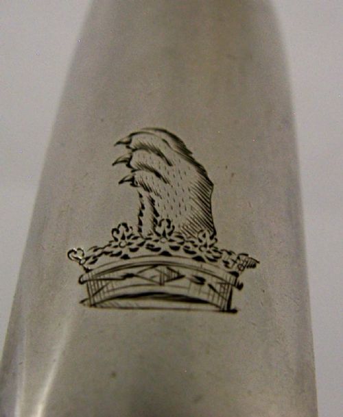 A Georgian sterling silver marrow scoop featuring an engraved family crest on the elongated scoop and stamped hallmarks along the narrow handle. View II
