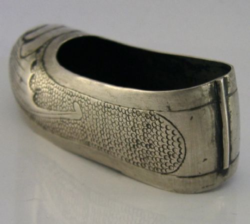 An antique Chinese export silver novelty pin cushion formed in the shape of a traditional slipper, featuring chased bat motifs and textured surface decoration. View VII